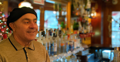 Bucky with a hat on at the bar